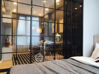 Modern bedroom with glass partition and cozy decor in stylish apartment