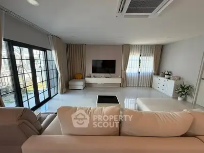 Spacious modern living room with large windows and elegant decor