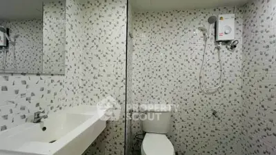 Modern bathroom with stylish tile design and efficient water heater system.