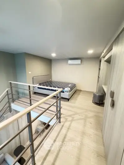 Modern loft bedroom with stylish railing and cozy ambiance