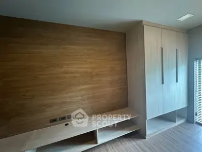 Modern bedroom with wooden accent wall and built-in wardrobe