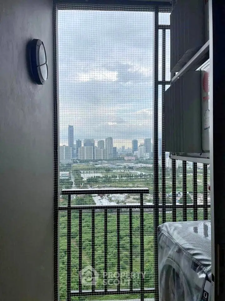 Stunning cityscape view from a high-rise balcony with lush greenery and skyline.