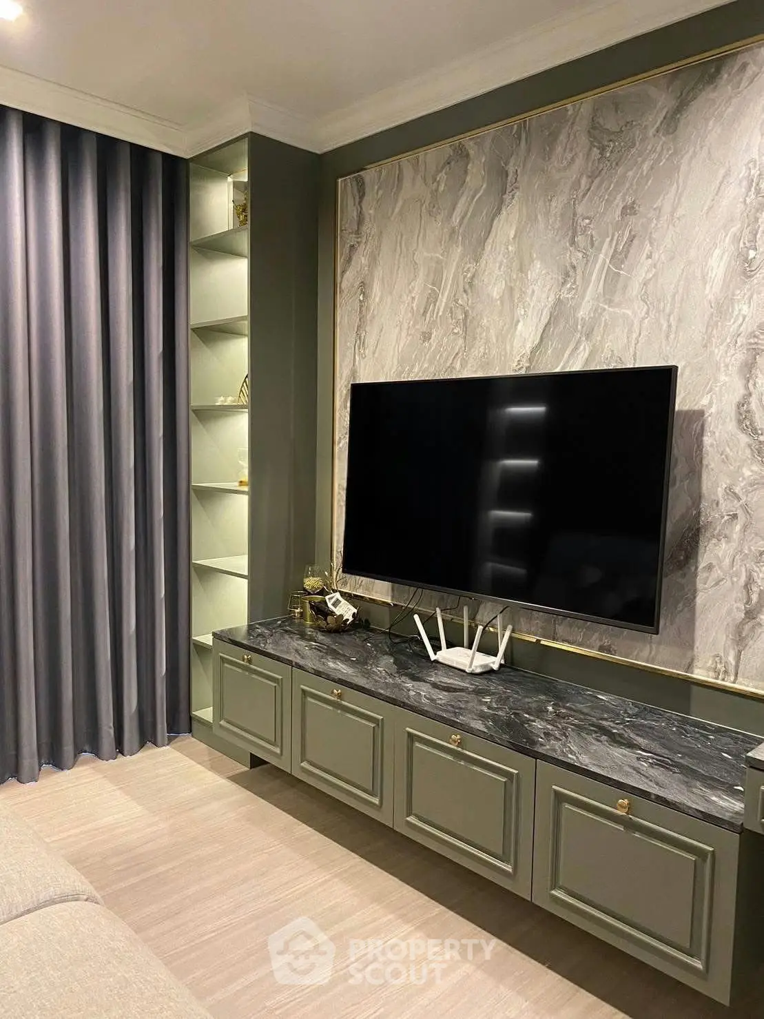 Elegant living room with modern TV setup and stylish marble accent wall
