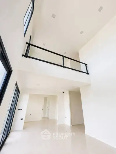 Spacious modern living room with high ceilings and mezzanine in a luxury apartment.