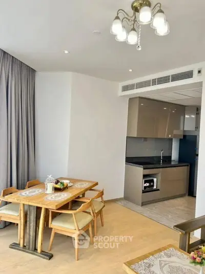 Modern dining area with open kitchen layout and elegant lighting