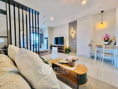 Modern open-plan living room with stylish decor and natural light