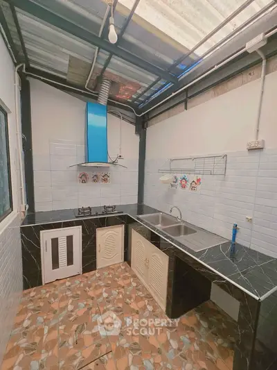 Charming kitchen with unique tile flooring and modern appliances in a cozy home setting.