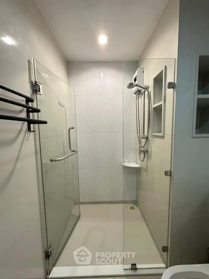 Modern bathroom with glass shower enclosure and sleek design.