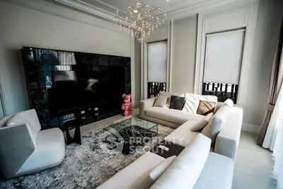 Luxurious modern living room with elegant chandelier and plush seating