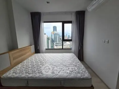 Modern bedroom with city view and large window in high-rise apartment