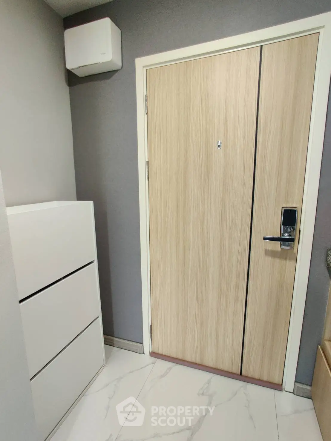 Modern apartment entrance with sleek wooden door and digital lock