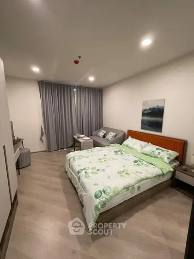 Modern bedroom with stylish decor and cozy ambiance, featuring a comfortable bed and elegant furnishings.