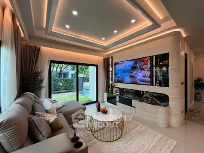 Luxurious living room with modern decor, large windows, and stylish ceiling lighting.