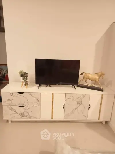 Modern living room with stylish marble cabinet and decorative horse statue.