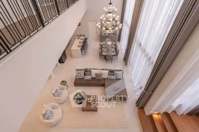 Luxurious open-plan living room with high ceilings and elegant chandelier