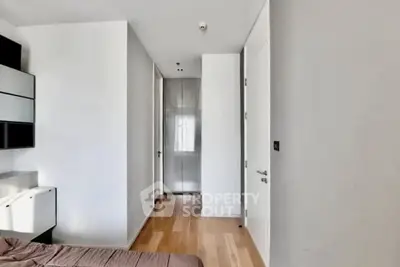 Modern minimalist bedroom with wooden flooring and sleek design