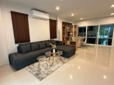 Spacious modern living room with sleek furniture and large windows for natural light.