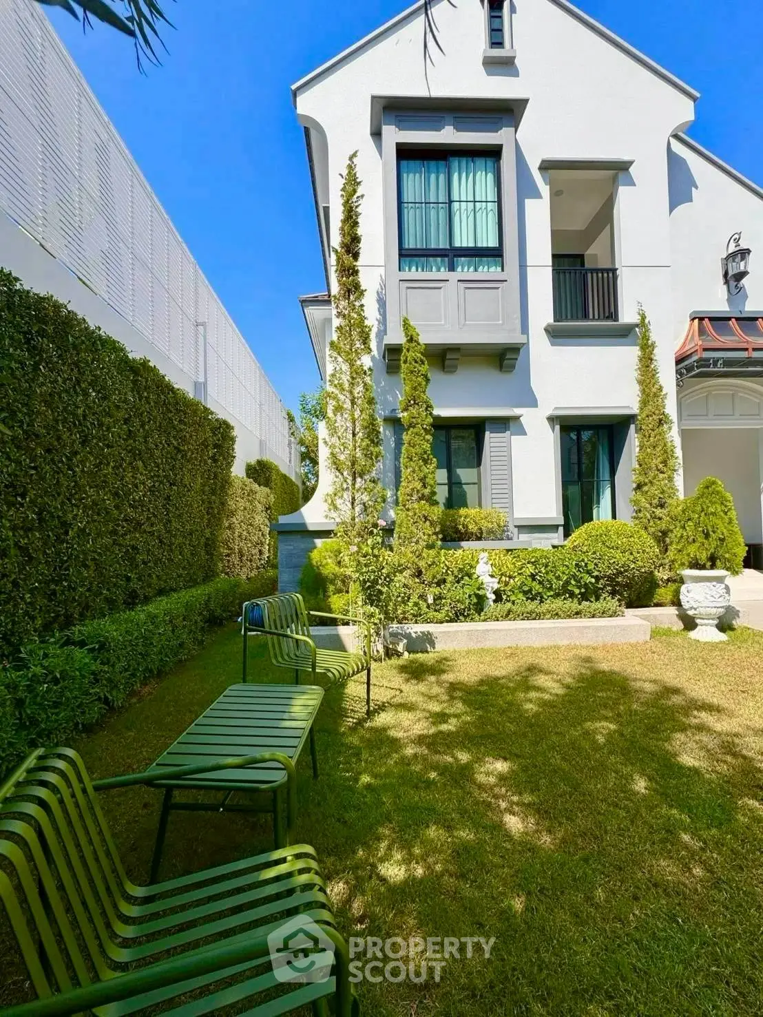 Charming two-story house with lush garden and modern architecture