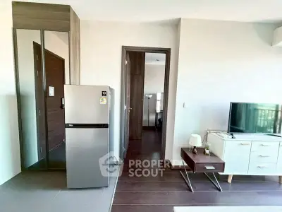 Modern apartment interior with sleek fridge and stylish TV unit