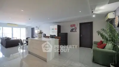 Spacious open-plan living room with modern kitchen and natural light