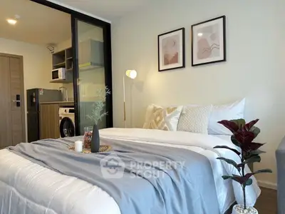 Modern bedroom with stylish decor and in-room washing machine for convenience.