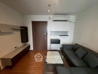 Modern living room with sleek furniture and air conditioning in a cozy apartment.