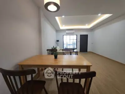 Spacious modern living room with wooden flooring and stylish furniture, perfect for family gatherings.