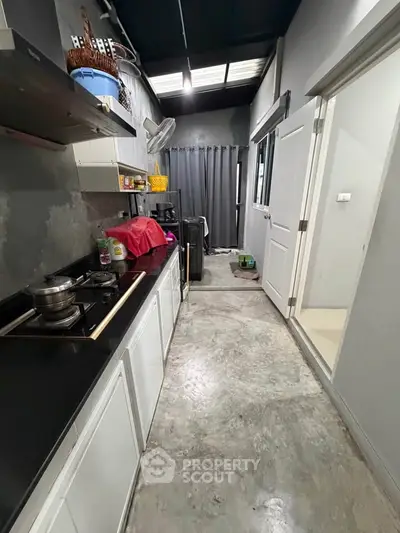 Modern kitchen with sleek countertops and gas stove in a compact layout