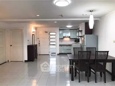 Spacious open-plan kitchen and dining area with modern appliances and elegant furniture.