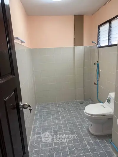 Spacious bathroom with modern fixtures and tiled flooring