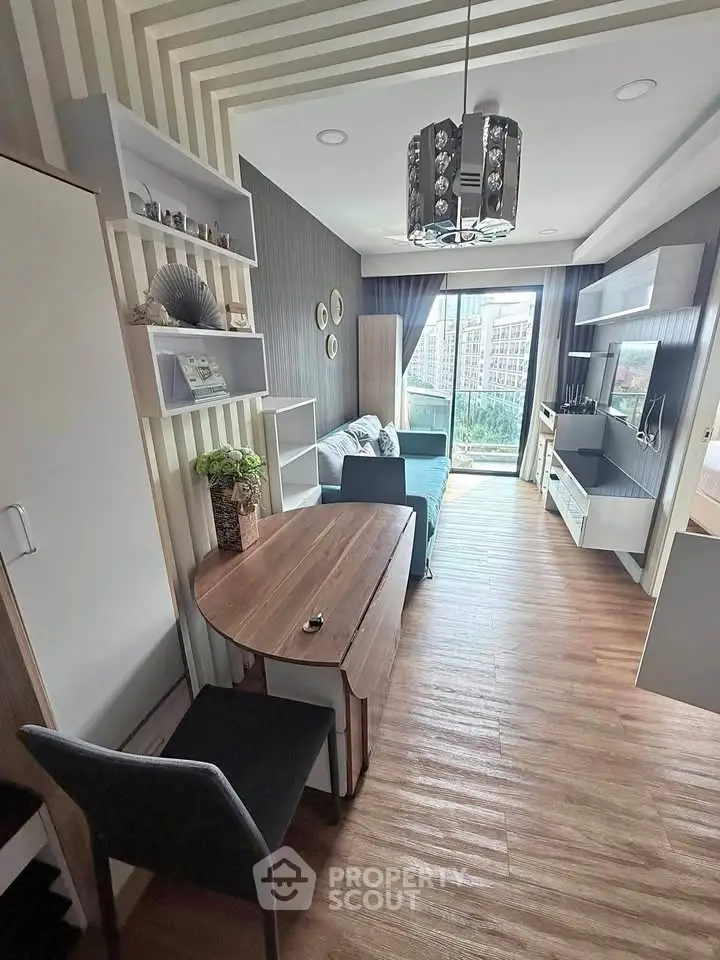 Modern living room with stylish decor and large window offering city view