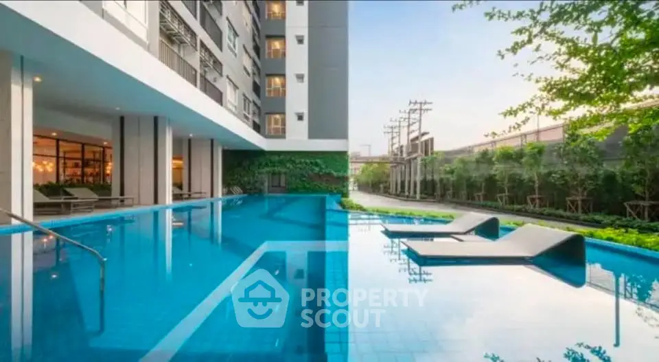 Luxurious apartment complex with stunning outdoor pool and lush greenery.