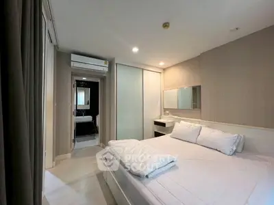 Modern bedroom with ensuite bathroom and sleek design in a stylish apartment.