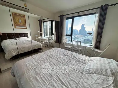 Modern bedroom with city view and mirrored closet doors