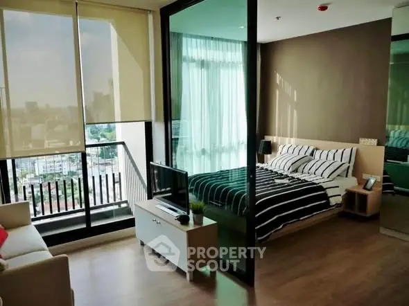 Modern studio apartment with balcony and city view, featuring stylish interior design and natural light.