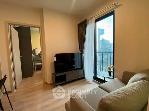 Modern living room with city view, cozy sofa, and large TV, perfect for urban living.