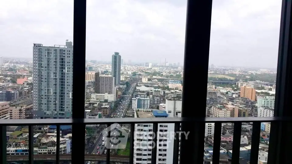 Stunning cityscape view from high-rise balcony overlooking urban skyline.