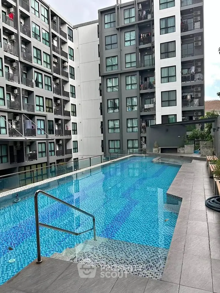 Modern apartment complex with inviting swimming pool and sleek design.