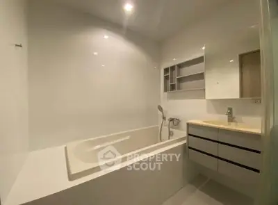 Modern bathroom with sleek bathtub and stylish vanity in a contemporary home.