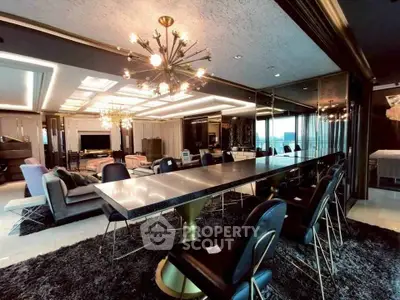 Luxurious modern living room with elegant dining area and stunning lighting fixtures.