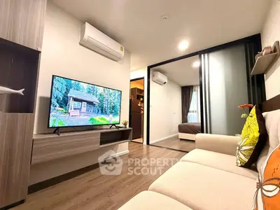 Modern living room with sleek design and cozy ambiance, featuring a large TV and stylish decor.