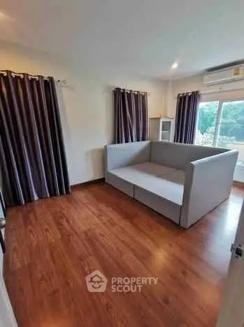 Spacious living room with modern sofa and hardwood floors