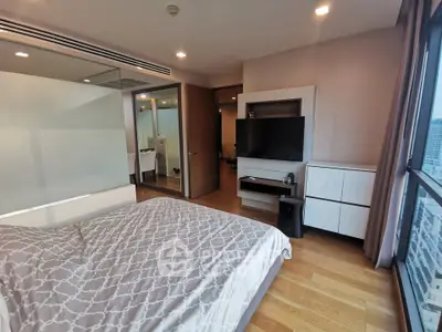 Modern bedroom with city view, featuring sleek furniture and large windows for natural light.