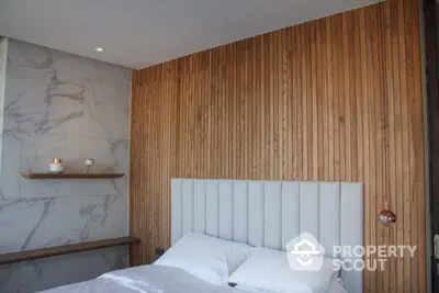 Modern bedroom with wooden accent wall and marble details