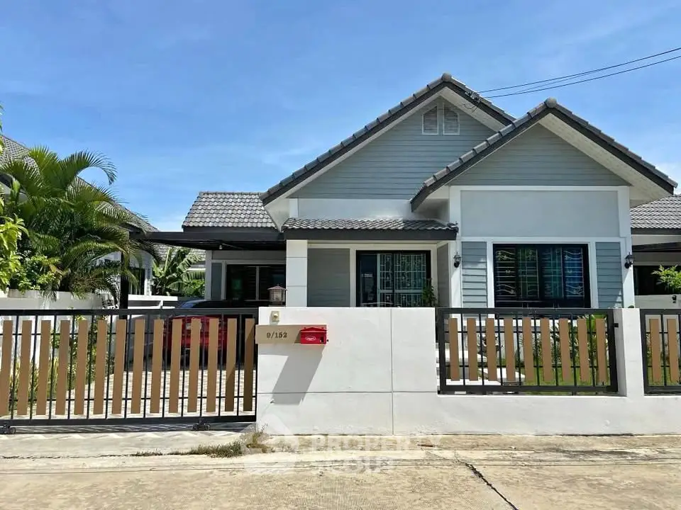 Charming single-story house with modern design and spacious front yard, perfect for family living.