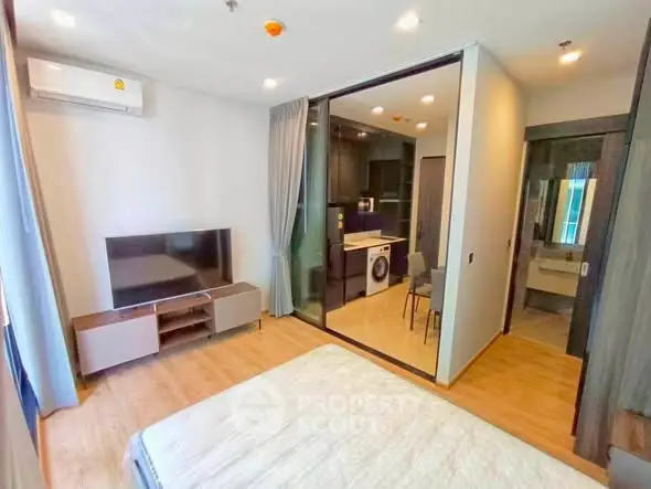 Modern studio apartment with open layout, featuring a cozy living area, compact kitchen, and stylish bathroom.