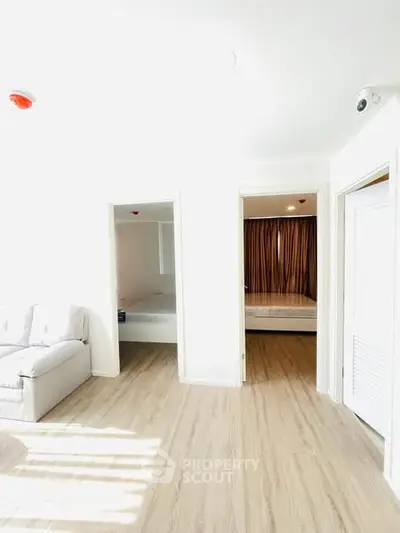 Bright modern apartment interior with light wood flooring and cozy furnishings