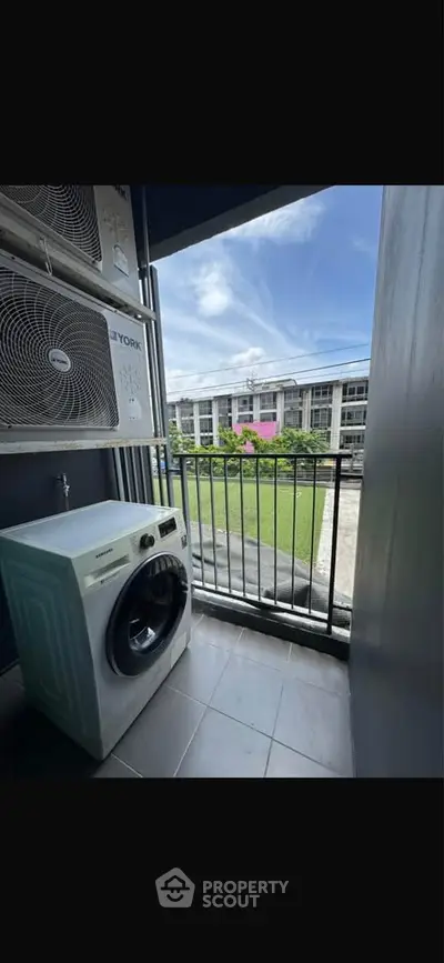 Modern balcony with washing machine and scenic view of residential complex