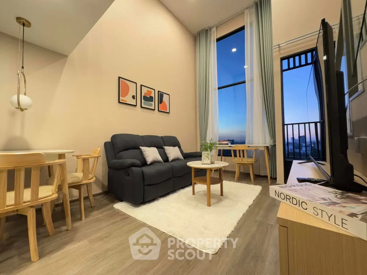 Modern living room with stylish decor and large window offering stunning city view