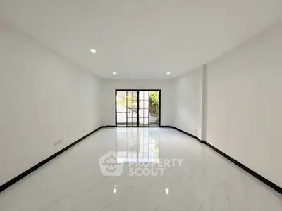 Spacious empty living room with large windows and marble flooring